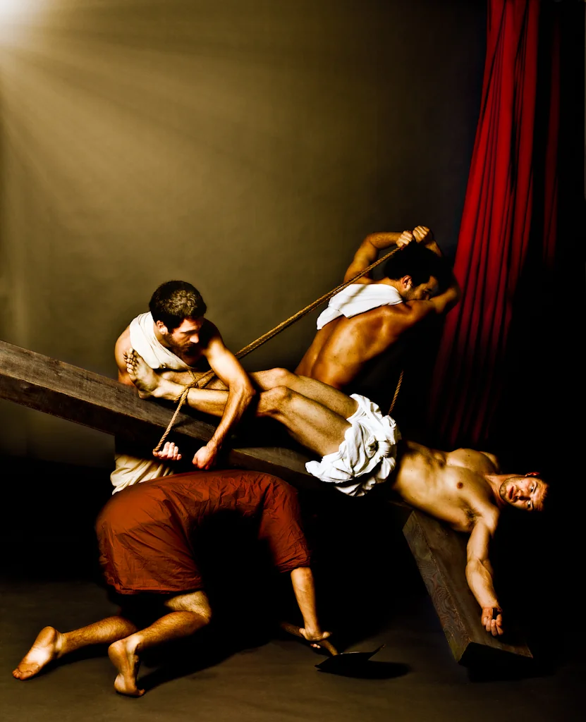 Theatrical group gathered around a fallen man