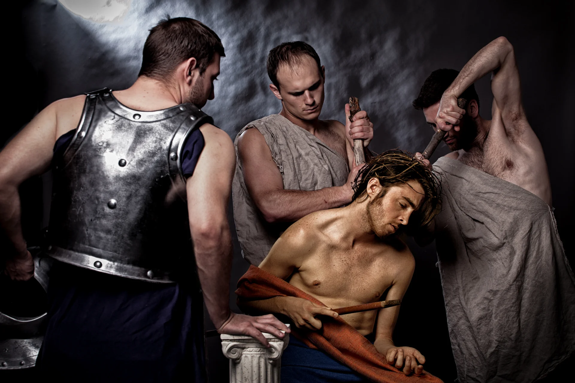 Armored figures surrounding a reclining wounded man
