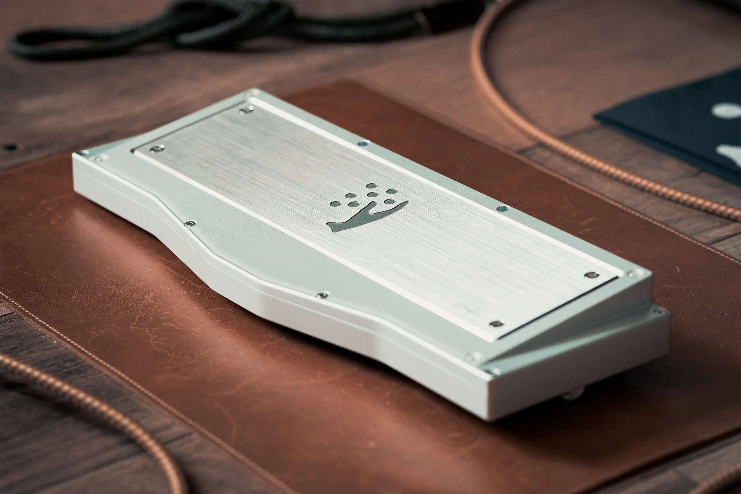Brushed metal keyboard case resting on a workbench