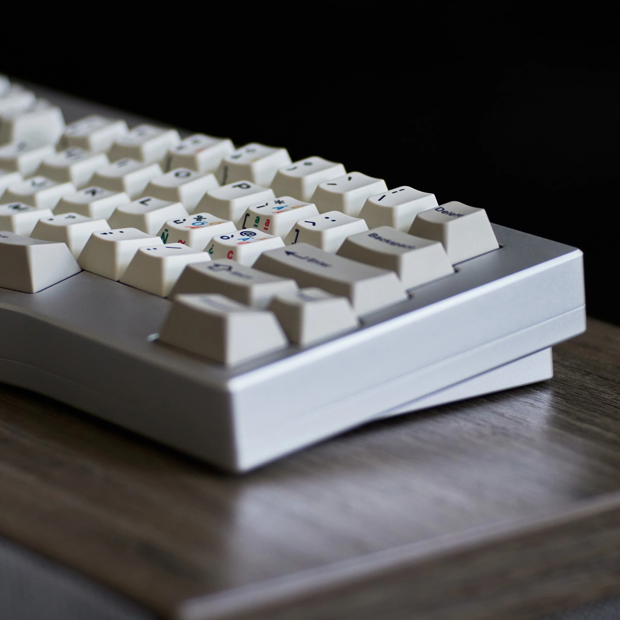 Compact white mechanical keyboard viewed from the side
