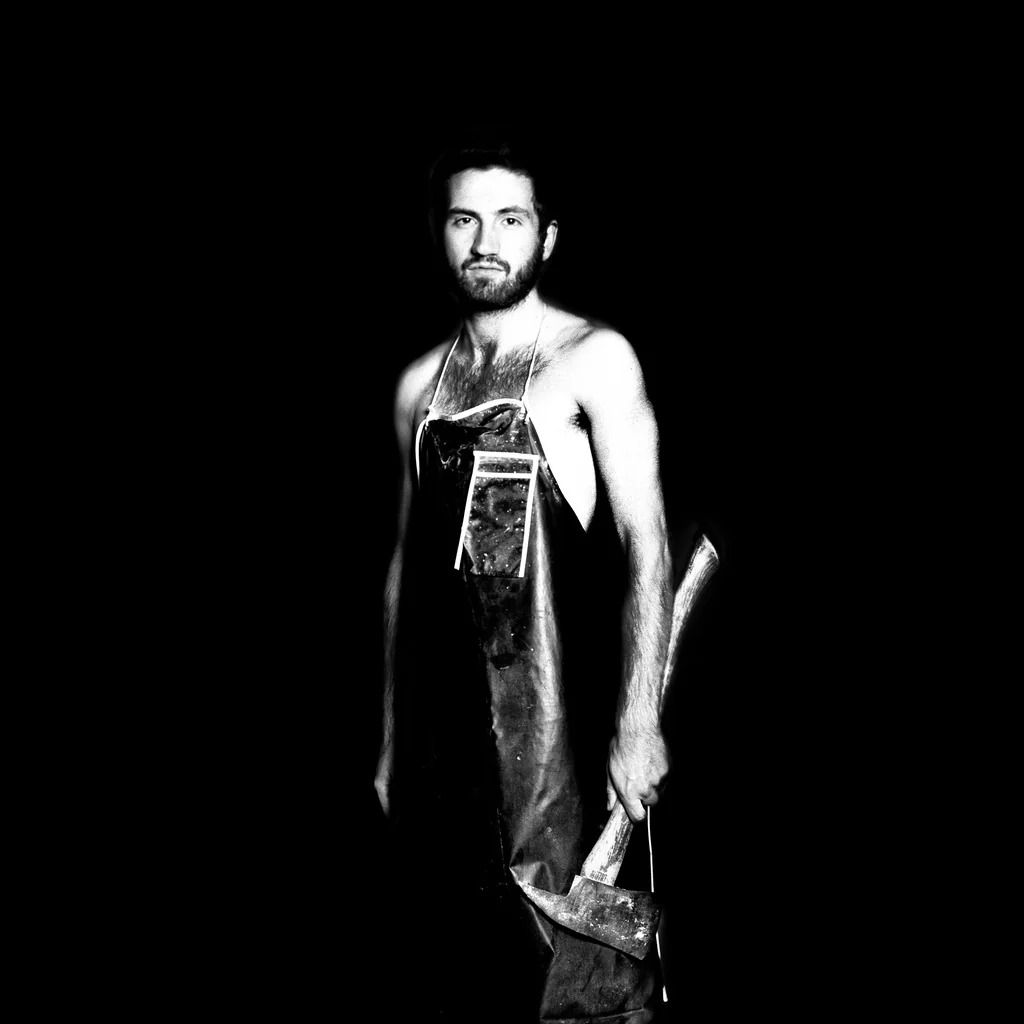 Full-length portrait of a man against a black background