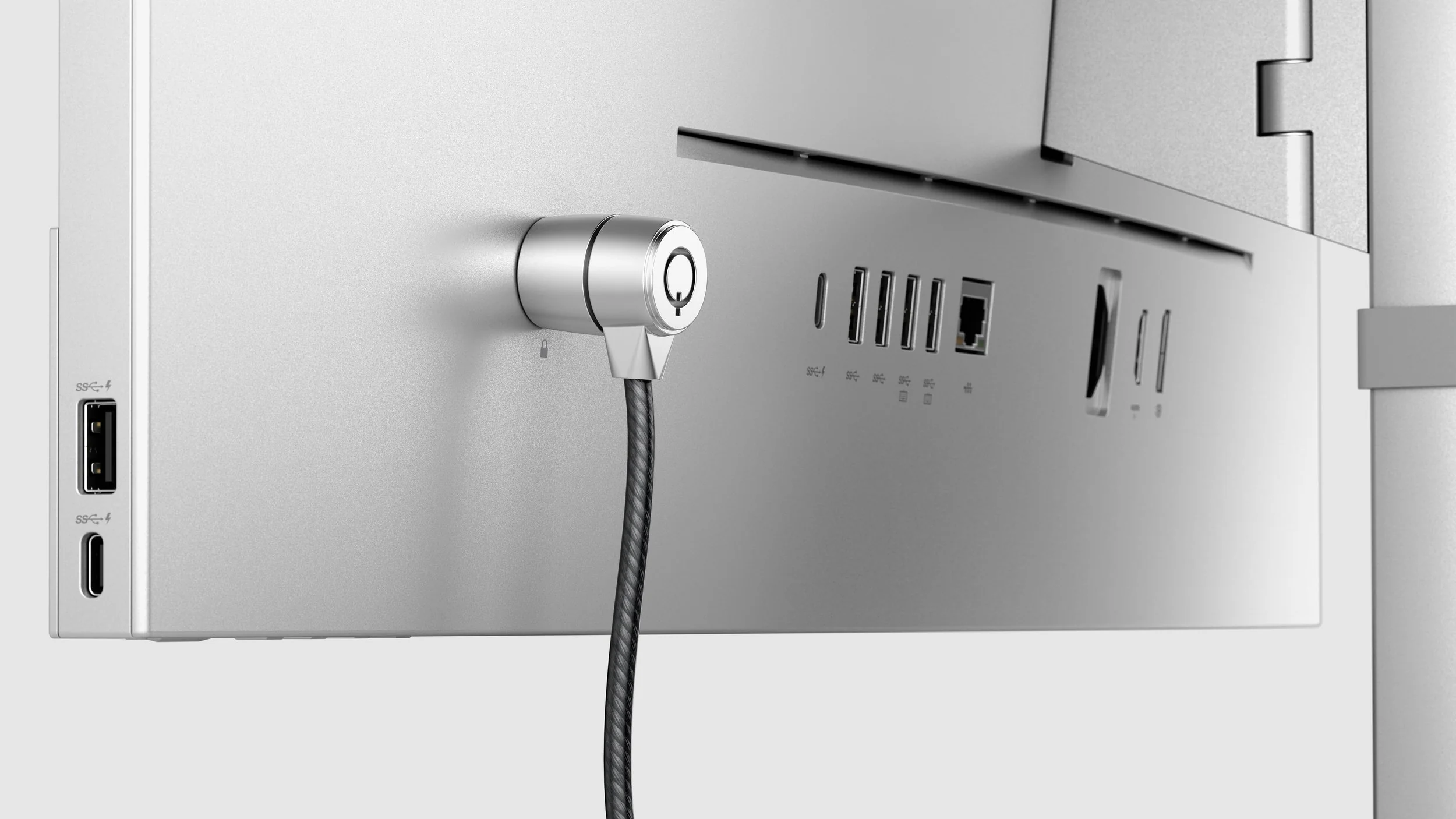 Security cable connected to the back of a silver monitor