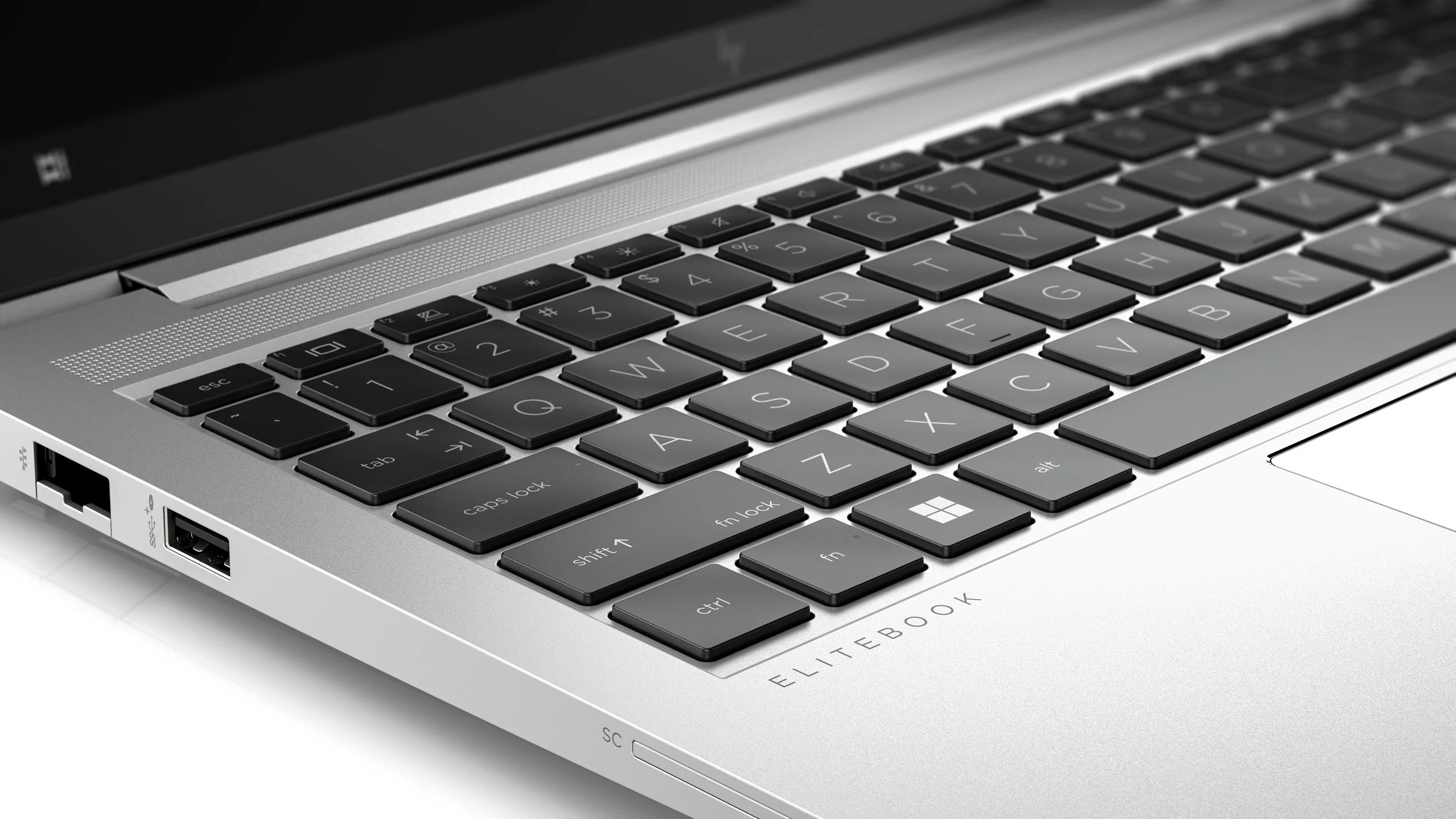 Close-up of a silver laptop keyboard and ports